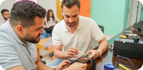 Two engineers working on a device prototype